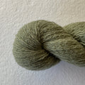 Close-up of Weeping Willow lace weight reclaimed cashmere yarn in a muted earthy sage green tone with soft halo.